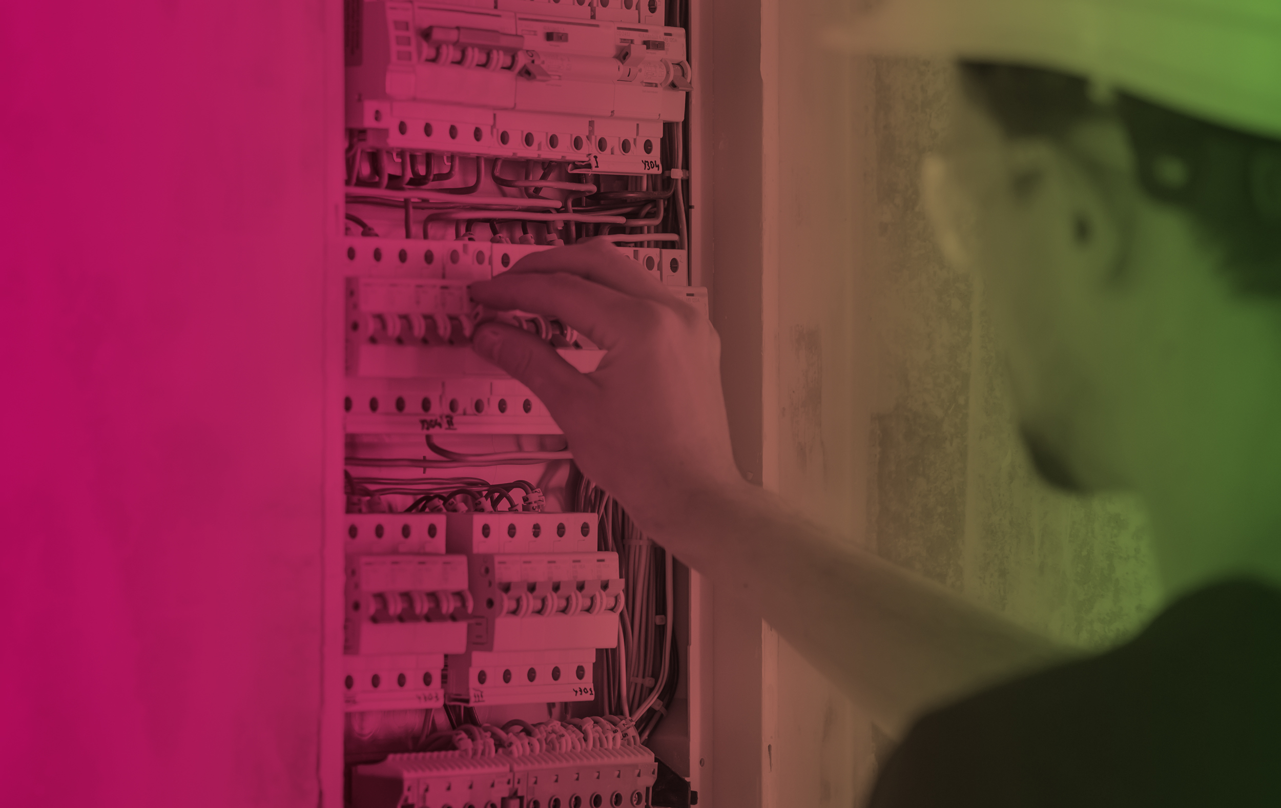 Man, an electrical technician working in a switchboard with fuses. Installation and connection of electrical equipment.